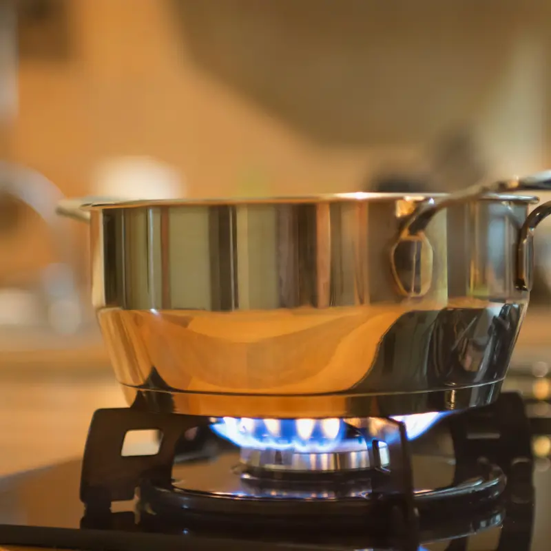 a pot boils on a natural gas stove top