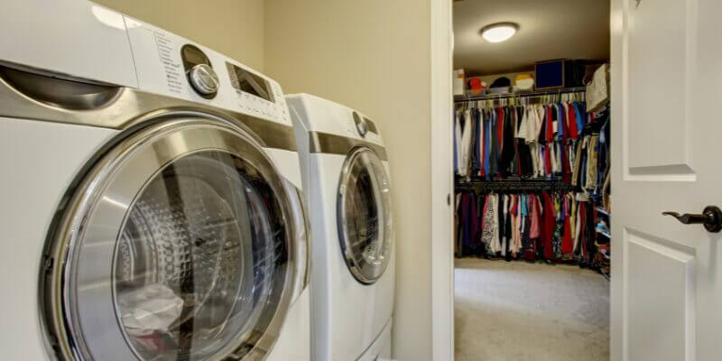 washer and dryer located in bedroom for easy access to hanging clothes.